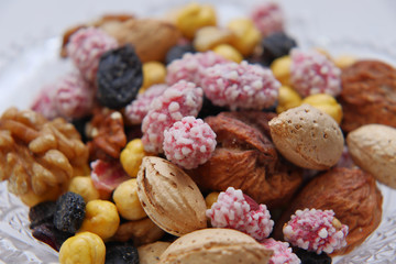 Sweet dried fruits and nuts in a crystal vase.