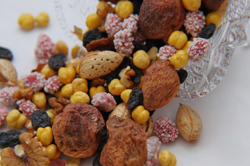 Sweet dried fruits and nuts in a crystal vase.