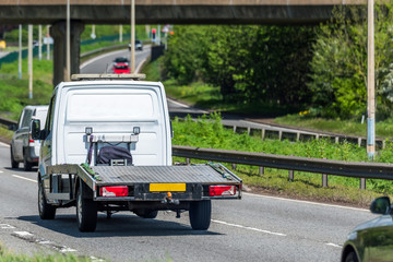 Fototapeta na wymiar empty tilt trailer truck on uk motorway in fast motion