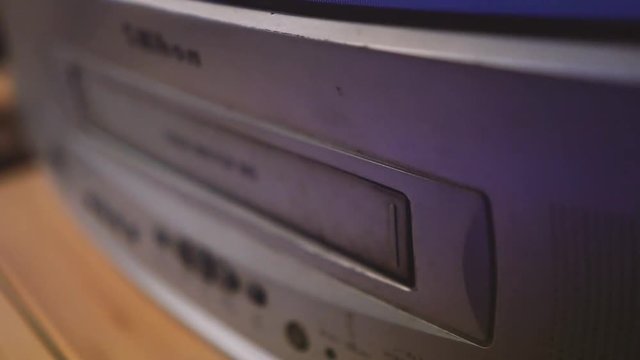 hand takes a video from the video player, Take a vhs tape from VCR