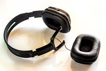 broken headphone, detachable headphones at work. concept of bad quality  listening earphones with...