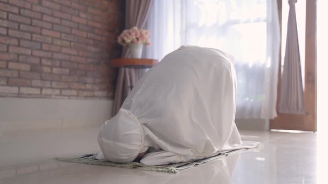 muslim woman sujud. asian woman praying or solat in islam prostration