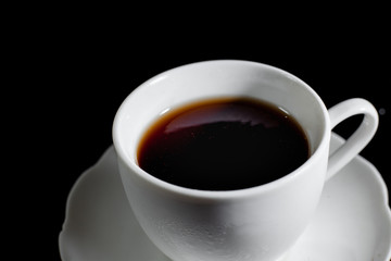 Pouring Black coffee into a coffee cup . Start a great day in the morning.
