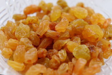 Sweet yellow raisins in a crystal vase.