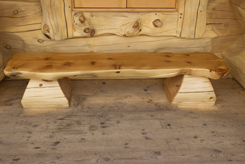 wooden bench of logs on the porch of the house