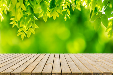 Empty wood plank table top with park green nature background