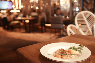 dinner at a restaurant grilled salmon / concept of a Mediterranean diet, seafood grilled and...