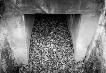 Greyscale image of an old concrete culvert
