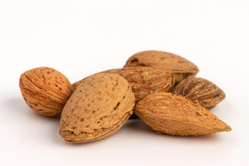 Raw almonds in shell isolated on white bacground