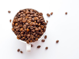 Coffee beans in white cup isolated on white background, drinks concept. top view