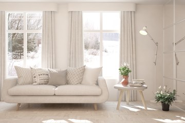 Fototapeta premium Stylish room in white color with sofa and winter landscape in window. Scandinavian interior design. 3D illustration
