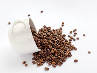 Coffee beans in white cup isolated on white background, drinks concept