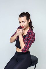 Young and beautiful girl in a shirt posing in the Studio. Portrait of a brunette girl.