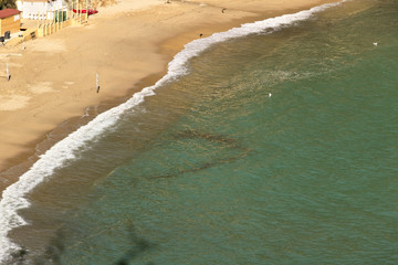 Sea waves break on the beach.