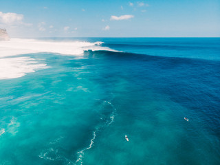 Naklejka na ściany i meble Aerial view of big wave surfing in Bali. Big waves in ocean