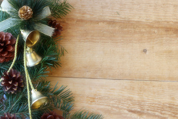 Christmas decorations - branches of coniferous trees with decorations on a wooden background.