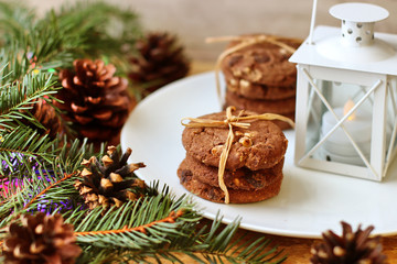 Christmas decorations - oat biscuits for Santa Claus and branches of coniferous trees