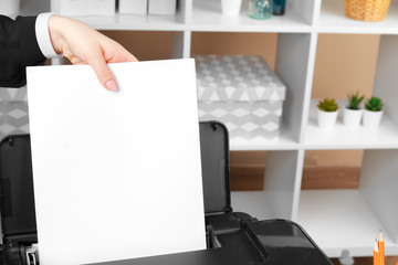 Woman using the printer to scanning and printing document