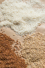Fototapeta na wymiar Raw cereals, buckwheat, barley, rice on paper background