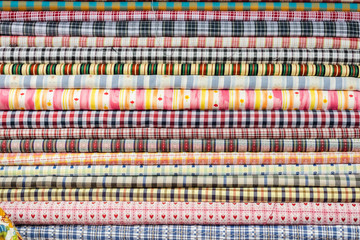 background of colorful fabric stacks