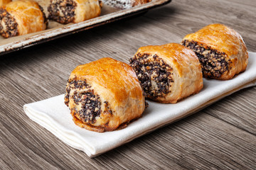 Crispy freshly baked cookies with poppy seeds on a wooden background.