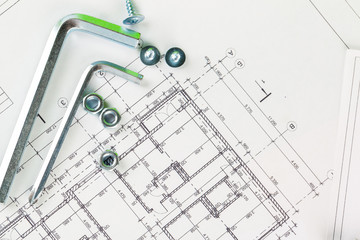 technology and metalworking. Metal bolt and nut on printed drawings background
