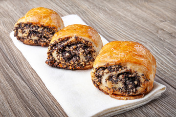 Crispy freshly baked cookies with poppy seeds on a wooden background.