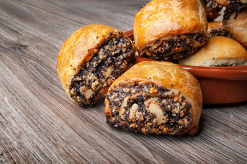 Crispy freshly baked cookies with poppy seeds on a wooden background.
