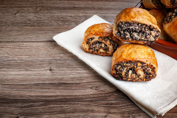 Crispy freshly baked cookies with poppy seeds on a wooden background.