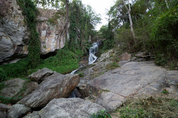 Huay Kaew Waterfall in tropical rain-forest, stones. Summer, travel, jungle concept. Copy space