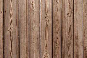 Background from smooth old wooden planks. Natural aging outdoors under the sun and rain.