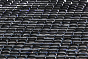 Multiple chairs outdoor, many black chairbacks