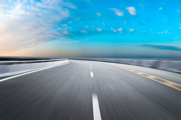 Motion-blurred highway in dusk clouds	