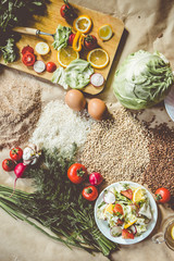 Organic food background with cutting board and lemon slices