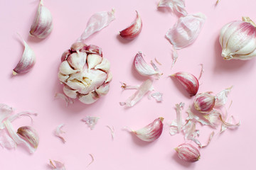 Fresh garlic on a light pink background