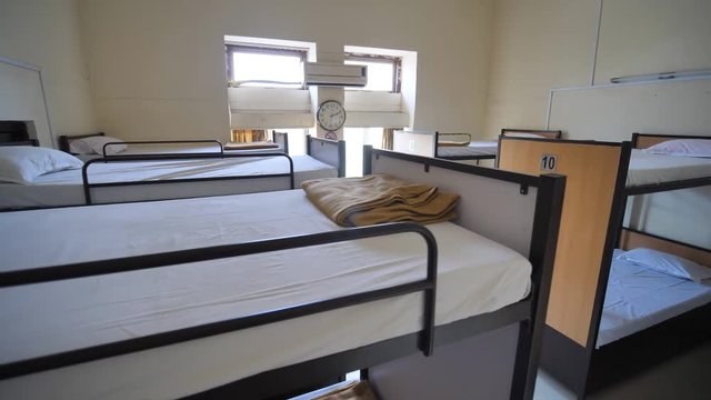 Empty room for a cheap hostel with bunk beds.