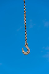 Crane hook against blue sky