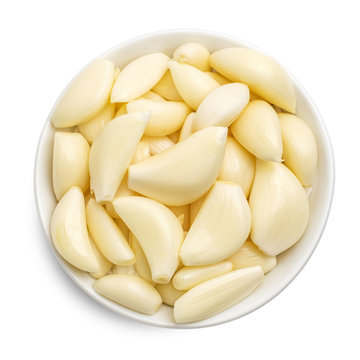 Isolated garlic in white bowl. Raw garlic segment isolated on white background. Top view