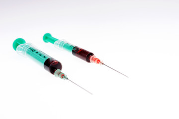 Two syringes with blood. Concept of blood donor day