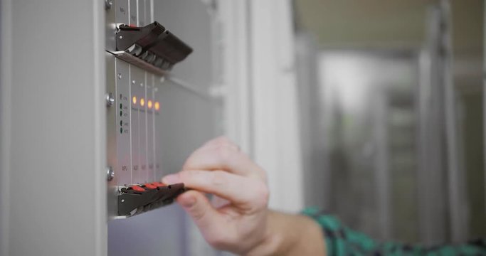 Male hand switches server communicators close up