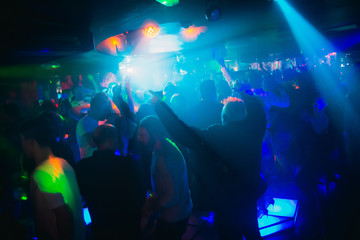 Fototapeta na wymiar crowd of people dancing in nightclub