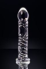 Clear colored Butt plug made of glass on a black background