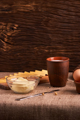 Assorted dairy products milk, cheese, butter rustic still life on table