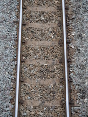 Top view of the train tracks with train and rock restraints in construction.