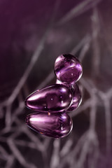 Clear colored Butt plug made of glass on a black background