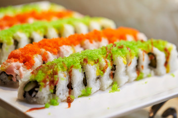 Sushi rolls with tobiko on top 