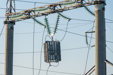 wires attached to the electric mast. The chaos of cables and wires on an electric pole. Many...