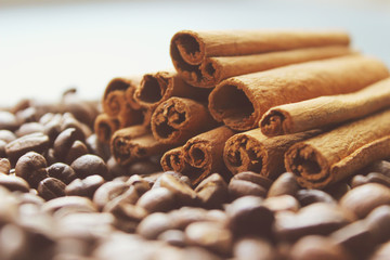Cinnamon sticks and coffee beans closeup. Aromatic coffee - coffee beans and cinnamon sticks. Background. Copy space.