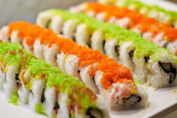 Sushi rolls with tobiko on top 