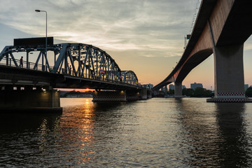 Fototapeta na wymiar Bridge across Chao Phraya River in the beautiful evening, Twilight time Bnagkok, Thailand. (Krung Thep Bridge)